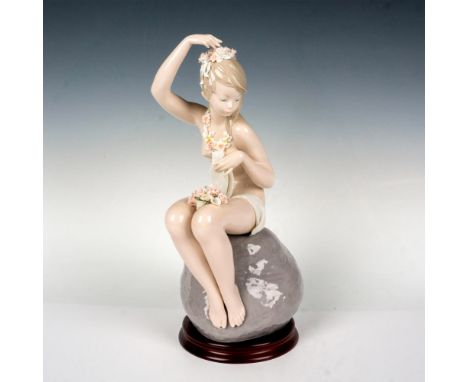 Depicts beautiful young girl sitting on a rock with flowers in her hair. Glossy finish. Lladro backstamp. This item has a bas