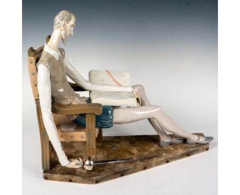 Glossy finish modeled as a large figure of Don Quixote reading a book while seated in a stately chair with his sword. Lladro 