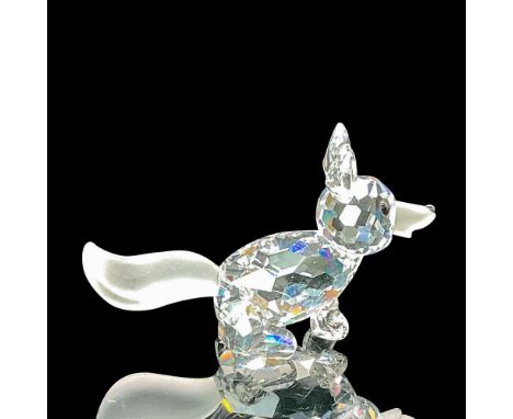 The fox figurine is adorned with a frosted nose and tail, along with black eyes and a black dot on the frosted nose. Swarovsk