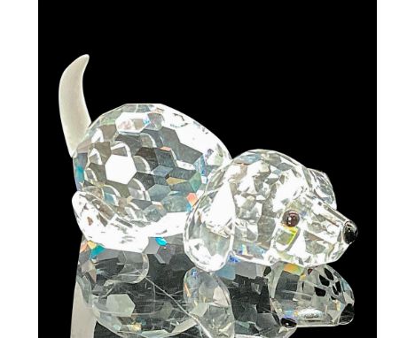 The cute faceted clear crystal beagle lies in a prone position ready to jump up and fetch his stick. He has a frosted crystal