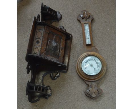 A late Victorian carved rustic oak corner cupboard, decorated with a bird to the door, and a 1920s banjo barometer/thermomete