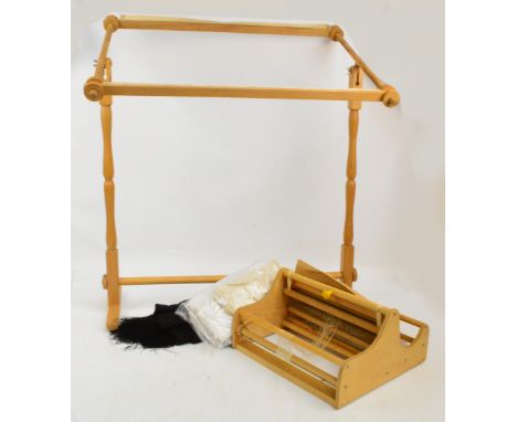 A freestanding wooden tapestry frame, a boxed Danish Kudumisteljed toy wooden loom with instruction leaflet and a quantity of