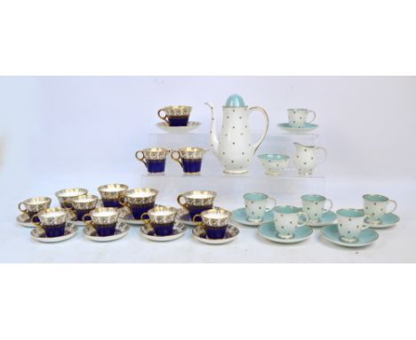 A Susie Cooper white and turquoise porcelain coffee set with gilt heightened rims and star motifs, comprising a coffee pot, h