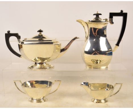 A George VI hallmarked silver three piece tea service with associated hot water jug, the three piece service with Art Deco oc
