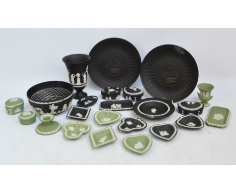 A collection of Wedgwood jasperware items, all either green or black ground, including vases, pin dishes, candlestick, plates