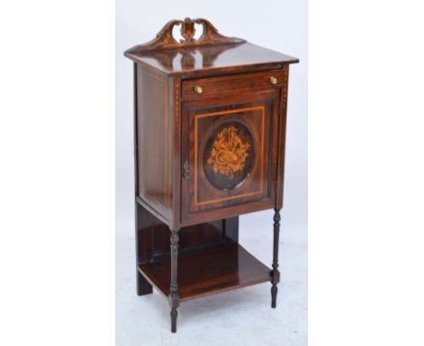 A late Victorian rosewood inlaid and satinwood detailed music cabinet with a frieze drawer, a single door enclosing three she