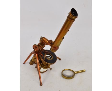 A late 19th century tripod folding lacquered brass field microscope inscribed "Swift", height 35cm, with additional magnifyin