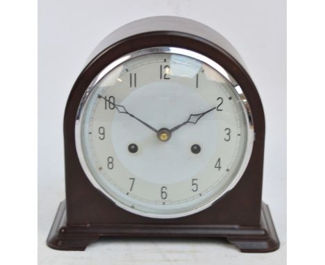 A brown bakelite cased Art Deco mantel clock with silvered dial set with Arabic numerals, height 21cm.