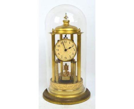 An early 20th century German Baduf mantel clock with circular dial set with Arabic numerals flanked by six fluted columns, ci