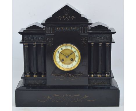 A late 19th century French black slate mausoleum mantel clock, the circular dial set with Arabic numerals housing an eight da