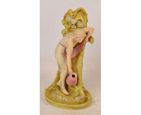 A Royal Dux figural vase modelled as a maiden holding a jug leaning against a tree at a stream, with applied triangle mark to