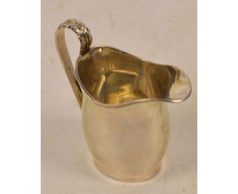 A George VI hallmarked silver helmet shaped cream jug with leaf capped loop handle, Lowe & Son, Chester 1939, height 9cm, app