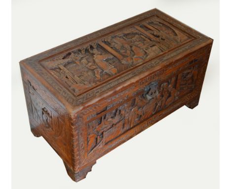 A 20th century camphor wood chest carved in relief with Chinese court scenes to each side, on stepped bracket feet, 94 x 45.5