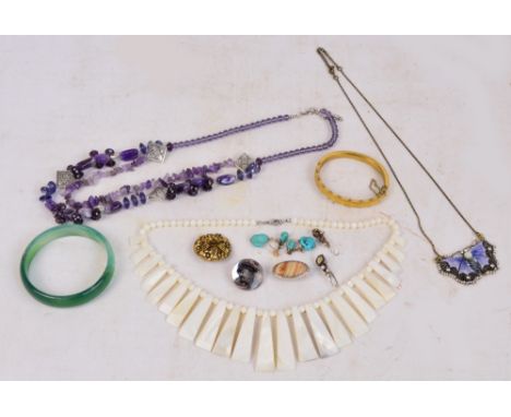 A small collection of costume jewellery including necklaces, gilt snap bangle, green hardstone bangle, purple stone necklace,