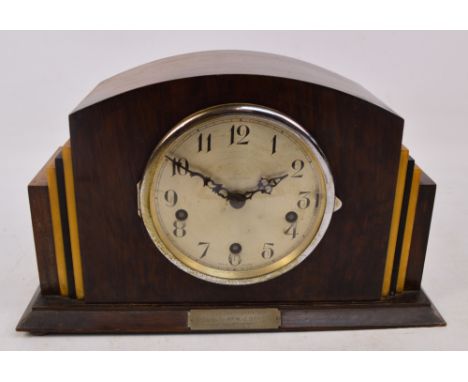 An Art Deco triple chime domed mantel clock, the circular silvered dial set with Arabic numerals, with presentation plaque "P