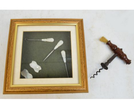 A late 19th century corkscrew with shaped mahogany handle set to one end with a brush, and button hook and manicure items wit