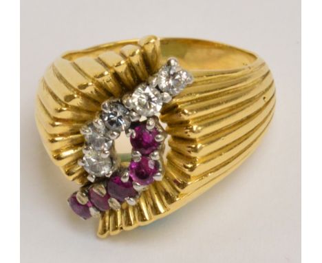 An 18ct yellow gold diamond and ruby ring, the shaped ribbed platform set with a row of five diamonds and five rubies, size M