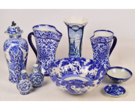 A small group of blue and white ceramics including two graduated Doulton Burslem jugs, a Chinese style transfer decorated bow