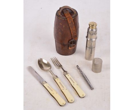 An early 20th century leather cased travelling cutlery set comprising folding knife, spoon and fork, cylindrical container fo