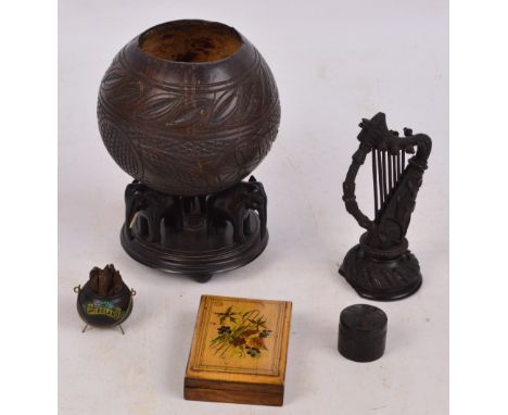 A carved Irish bog oak model of a harp decorated with shamrock motifs, height 14.5cm, a similar cylindrical box and cover, di