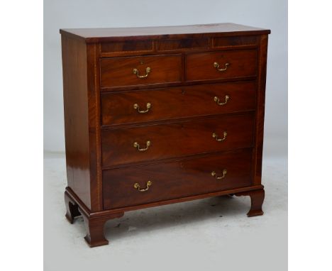 A late 19th century mahogany and inlaid chest of drawers with "secret" frieze drawer above two short and three long graduated