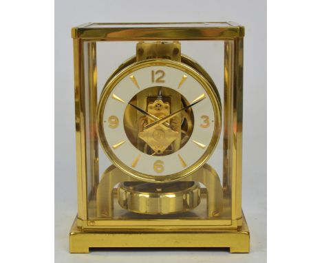 JAEGER-LECOULTRE; an Atmos clock with circular chapter ring set with Arabic numerals and gold batons in stepped bracket case,