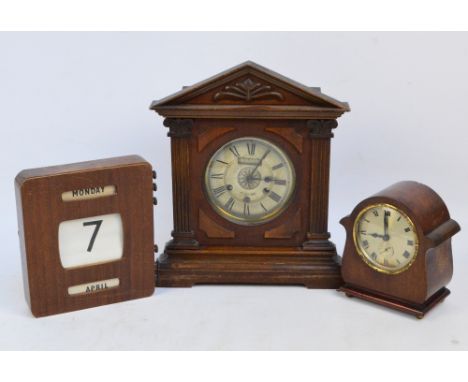A c.1900 walnut cased mantel clock, the silvered dial set with Roman numerals and with Arabic alarm numerals and with silent/