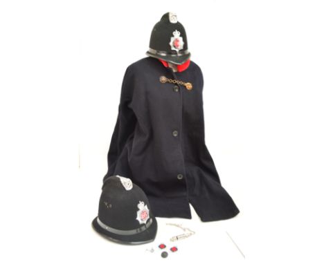 A collection of items relating to the police comprising two police helmets, a whistle inscribed "The Metropolitan", a Lancash