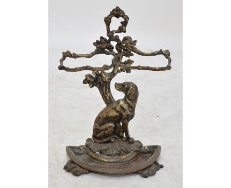 A Victorian cast iron stick stand modelled as a seated dog beneath tangled branches acting as two section umbrella holders ab