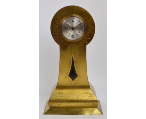 A decorative brass balloon shaped mantel clock, the circular silvered dial set with Arabic numerals above engraved shaped cas