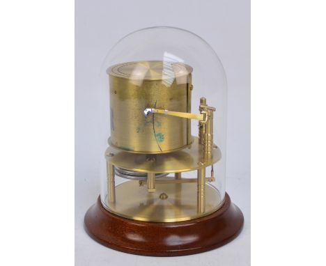 A Met-Check dome barograph fixed to a wooden plinth, the barograph inscribed "Gluck Barograph and Recorder Co. Lt. Made in En