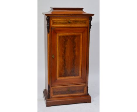 A Danish mahogany and birds eye maple crossbanded side cabinet with single pull-out frieze drawer above a door and further dr