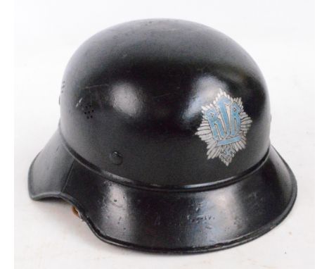 A German Third Reich helmet with later decal, repainted and restored with later liner.