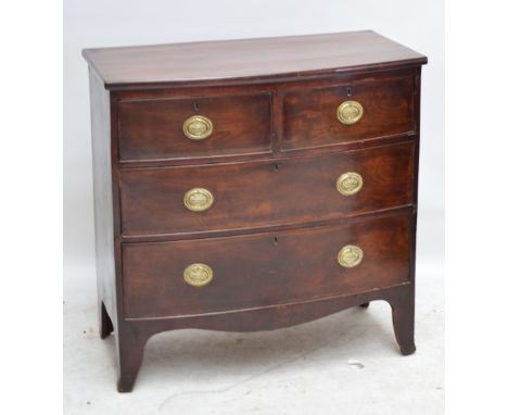 A George IV bowfronted chest of small proportions, the shaped top above two short and two long drawers raised on splayed brac