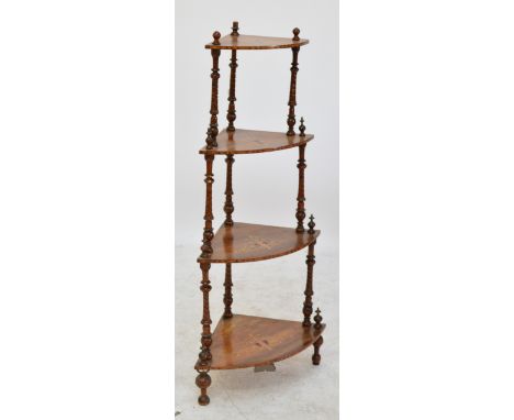A Victorian walnut and inlaid bowfronted four tier whatnot with turned columns, 133cm including finial.