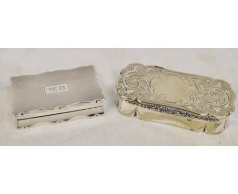 A George V hallmarked silver snuff box of shaped rectangular form with overall engine turned decoration, centred with rectang