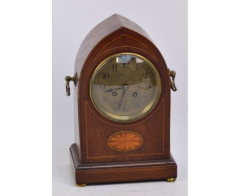 An Edwardian mahogany boxwood and satinwood inlaid lancet shaped mantel clock, the silvered dial set with Arabic numerals hou