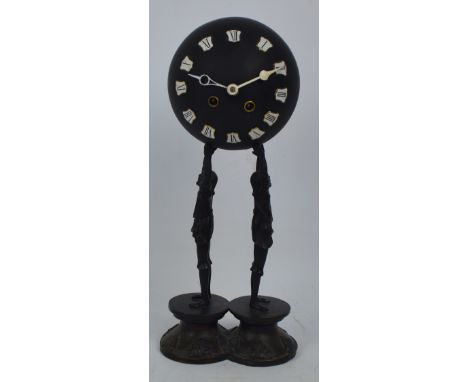 A c.1900 spelter figural ball clock, the upper globe set with Roman numerals housing an eight day Marti Brothers movement, no