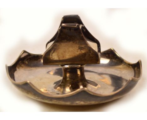 A George V hallmarked silver matchbox holder raised on circular dish with shaped raised rim, Sander & McKenzie, Birmingham 19