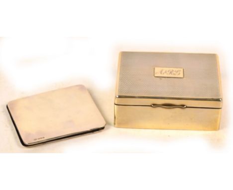 A George V hallmarked silver cigarette box of rectangular form with engine turned decoration to the hinged lid centred with a