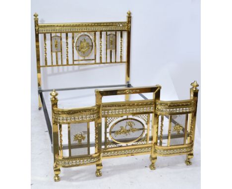 An Edwardian polished brass double bedstead with central gilt mesh panel of a bird with figural motifs either side, square su