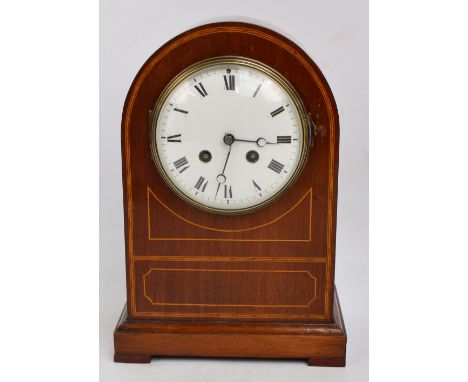 An Edwardian mahogany, satinwood inlaid and boxwood strung mantel clock, the white enamel dial set with Roman numerals housin