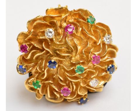 KUTCHINSKY; an 18ct yellow gold diamond, emerald, ruby and sapphire floral set circular brooch/pendant, the raised textured b