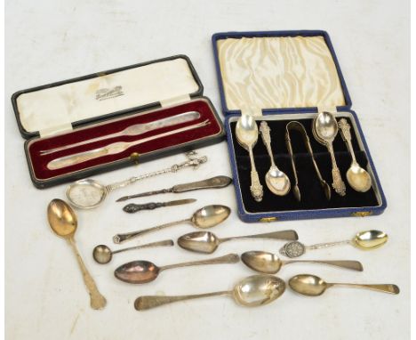 A cased set of nine George V hallmarked silver coffee spoons with cast masque and grotesque decorated finials, with vacant ca