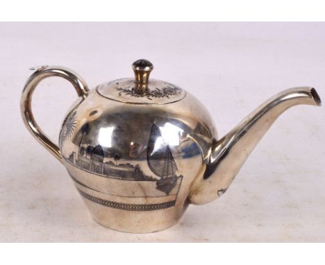 An early 20th century Iraqi silver and niello globular teapot decorated with Middle Eastern buildings, length 24cm, approx 11