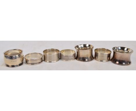 Two pairs of George V hallmarked silver silver napkin rings by Charles Horner, one with engine turned decoration, other of pl