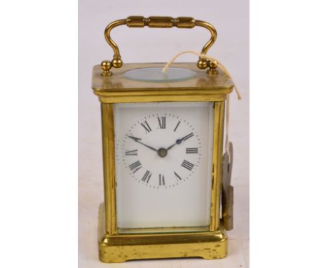 An early 20th century brass carriage clock, the enamel rectangular face with circular chapter ring set with Roman numerals, t