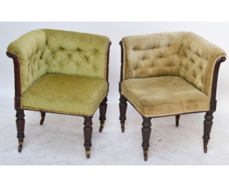A very near pair of Victorian mahogany framed button upholstered corner chairs raised on ring turned legs to castors.