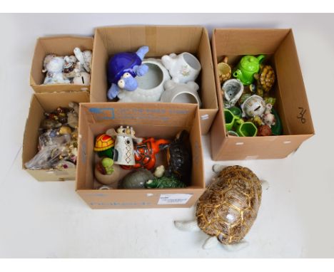 An extensive collection of various ceramic turtles in various sizes, some acting as trinket boxes, flower pot, money boxes, t