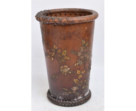 A late Victorian/Edwardian leather stick stand/bin, with raised gilt heightened floral decoration bearing label to base "Finn